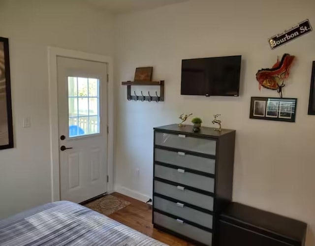bedroom featuring wood finished floors and baseboards