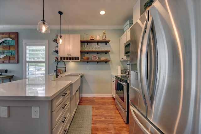 704 Burleson St, Brenham, TX 77833 - kitchen with stainless steel appliances, open shelves, light wood-style floors, light countertops, and a peninsula