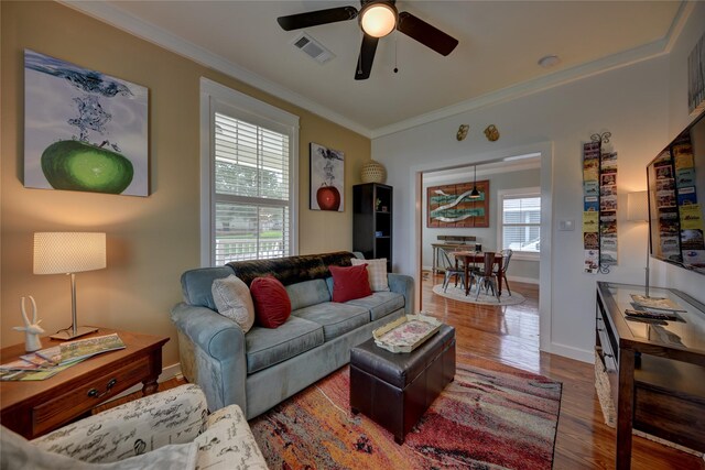 704 Burleson St, Brenham, TX 77833 - living area featuring wood finished floors, crown molding, and a ceiling fan