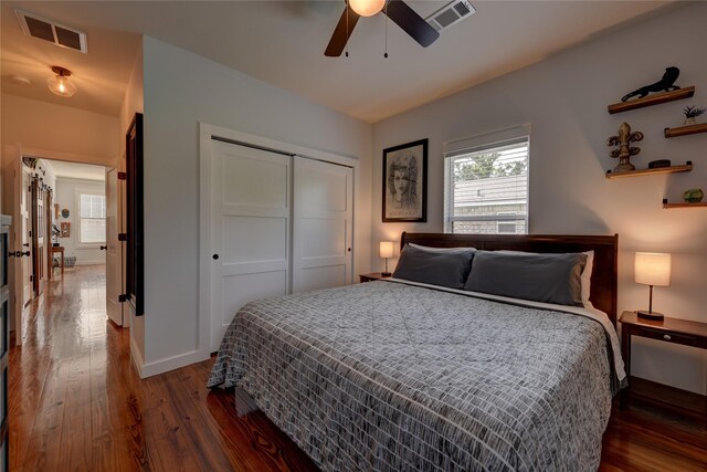704 Burleson St, Brenham, TX 77833 - bedroom with wood-type flooring, a closet, and a ceiling fan