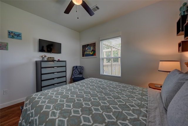 704 Burleson St, Brenham, TX 77833 - bedroom with wood finished floors and ceiling fan