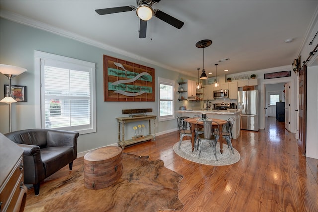 704 Burleson St, Brenham, TX 77833 - dining area featuring crown molding, wood finished floors, and a ceiling fan