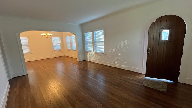 4701 Avenue N 1/2 Ave N 1/2, Galveston, TX 77551 - foyer featuring arched walkways, dark wood-style flooring, ornamental molding, and a chandelier
