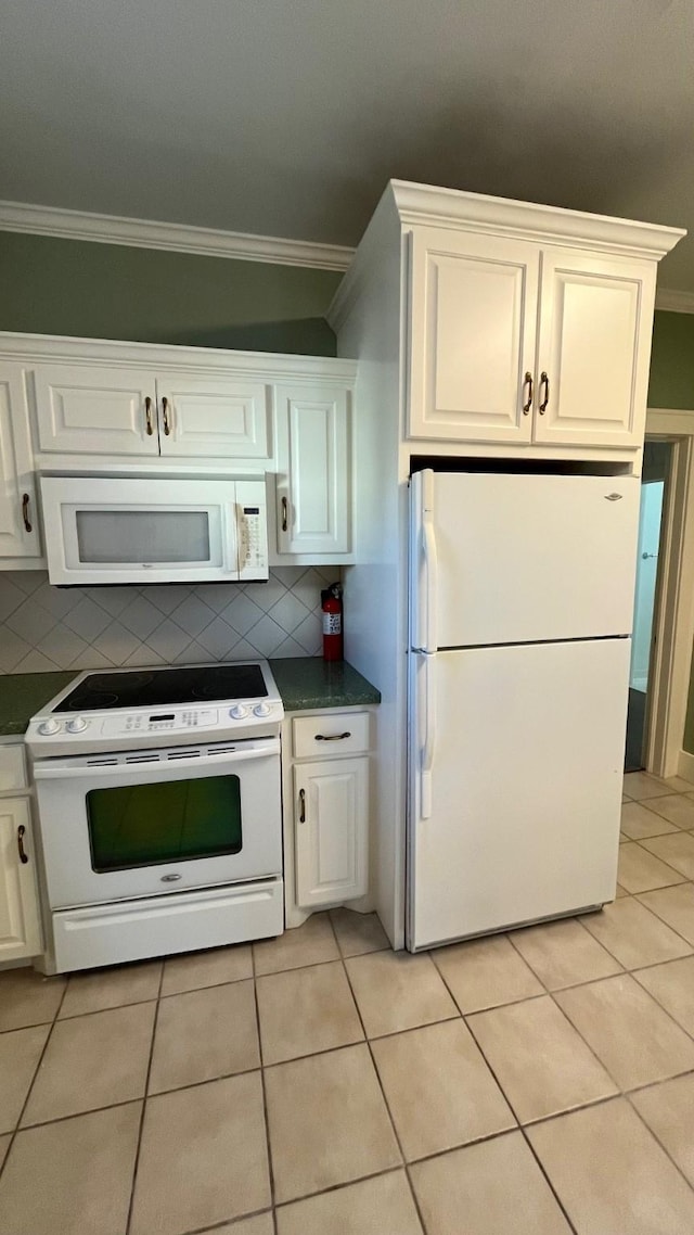 4701 Avenue N 1/2 Ave N 1/2, Galveston, TX 77551 - kitchen with backsplash, dark countertops, ornamental molding, and white appliances
