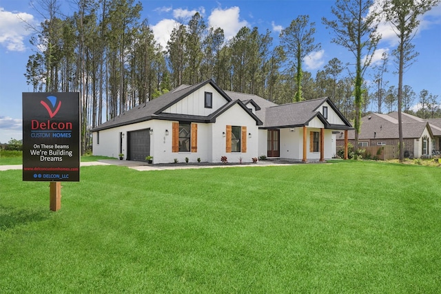 679 Rd 66111, Dayton, TX 77535 - view of front of house featuring a front lawn, driveway, and a garage
