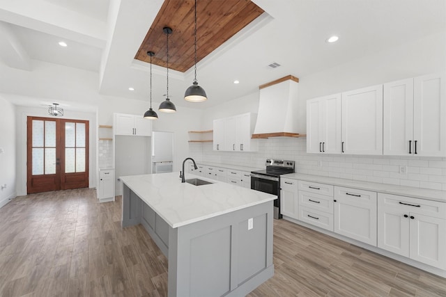 679 Rd 66111, Dayton, TX 77535 - kitchen with a sink, tasteful backsplash, open shelves, custom exhaust hood, and electric range