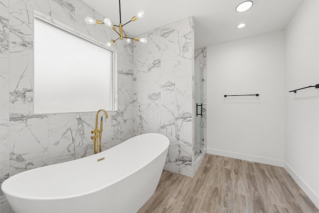 679 Rd 66111, Dayton, TX 77535 - full bath with tile walls, a marble finish shower, recessed lighting, a chandelier, and a freestanding bath