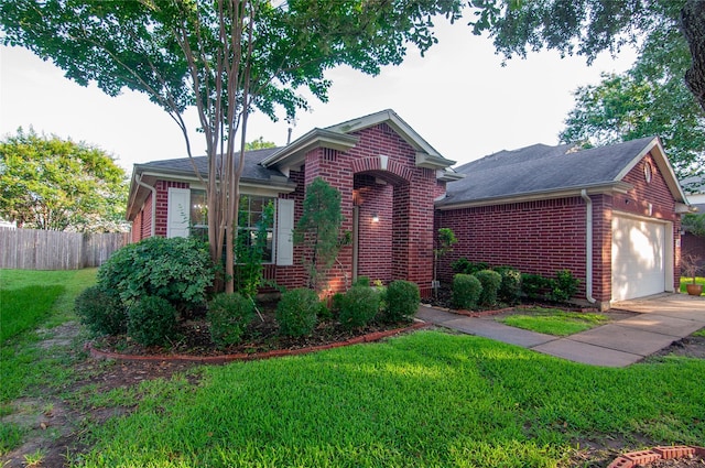 ranch-style home featuring brick siding, roof with shingles, fence, and a front yard