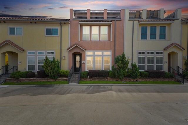26 W Oaks Dr, Houston, TX 77058 - view of property with a tiled roof and stucco siding