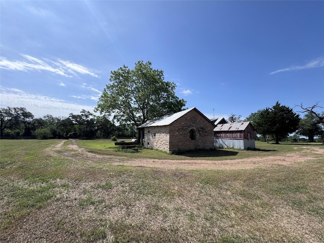 6346 Sand Rock Ln, Grange, TX 78945 - view of side of property featuring a lawn, an outbuilding, and a barn