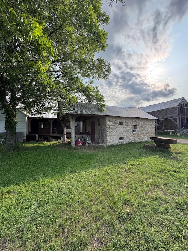 6346 Sand Rock Ln, Grange, TX 78945 - rear view of property featuring a yard and stone siding