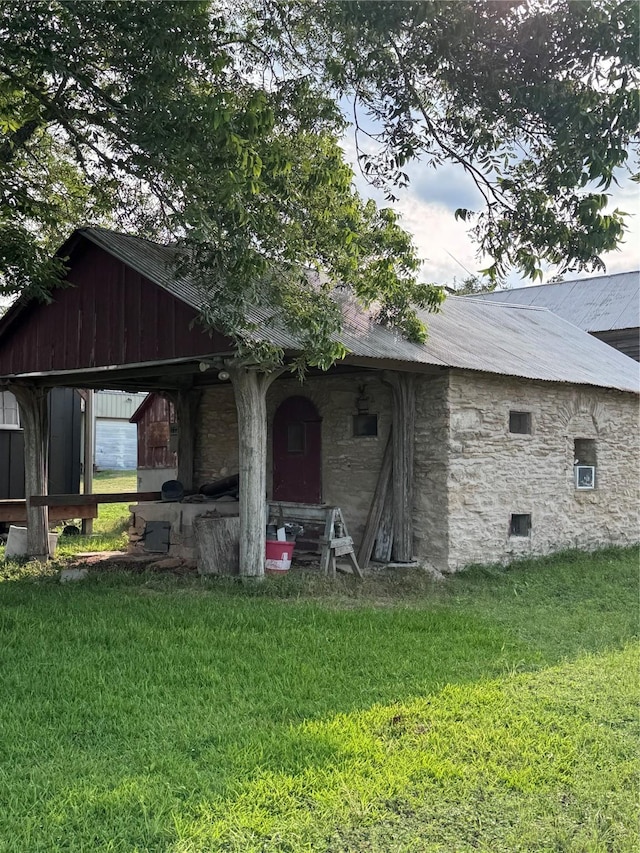 6346 Sand Rock Ln, Grange, TX 78945 - view of front of home with a front lawn, metal roof, and stone siding