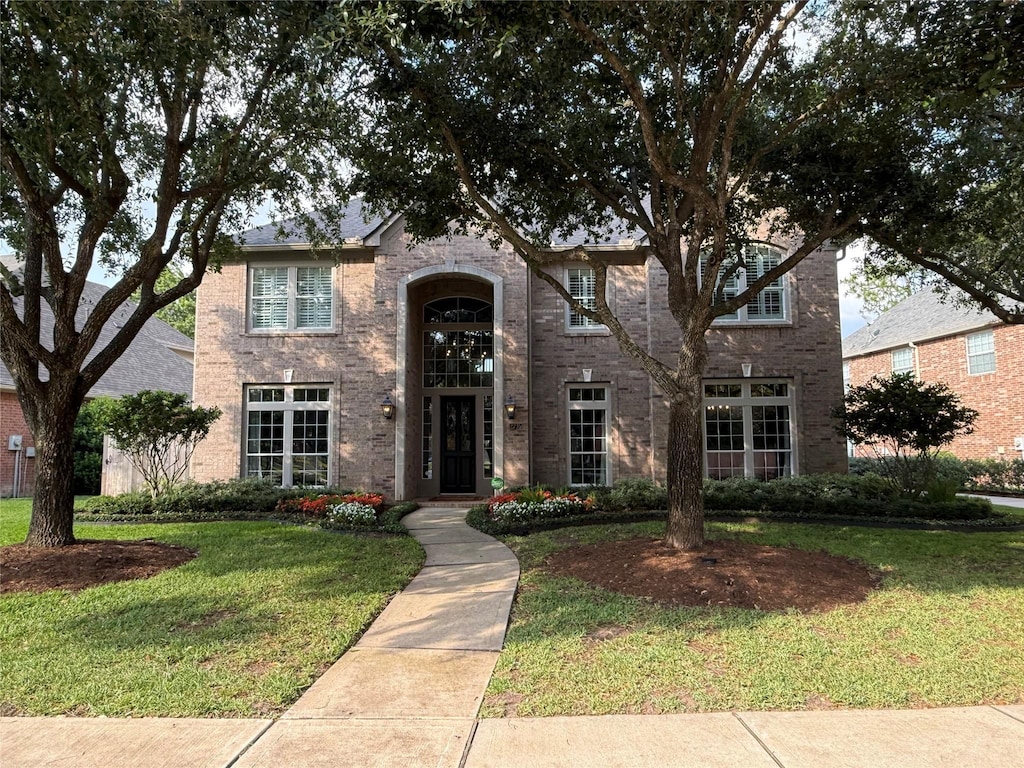 2735 Zachary Bend Ln, Katy, TX 77494 - traditional-style home with a front yard and brick siding