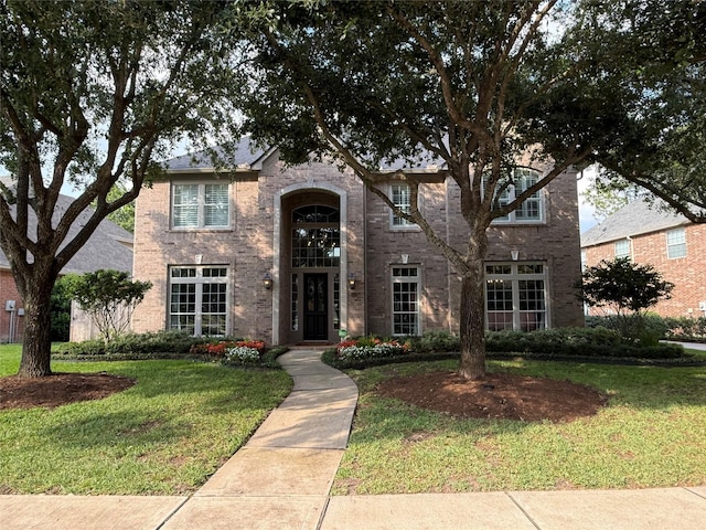 2735 Zachary Bend Ln, Katy, TX 77494 - traditional-style home with a front yard and brick siding