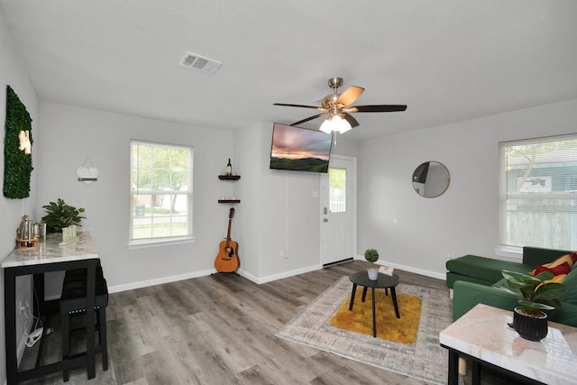 5410 Bataan Rd, Houston, TX 77033 - living area with healthy amount of natural light, baseboards, and wood finished floors