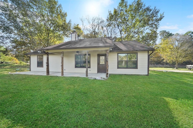 22981 Henson Rd, Montgomery, TX 77356 - back of property featuring a ceiling fan, a patio area, a chimney, and a yard