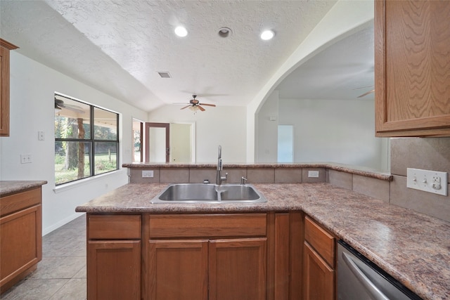 22981 Henson Rd, Montgomery, TX 77356 - kitchen with a textured ceiling, stainless steel dishwasher, ceiling fan, and a sink