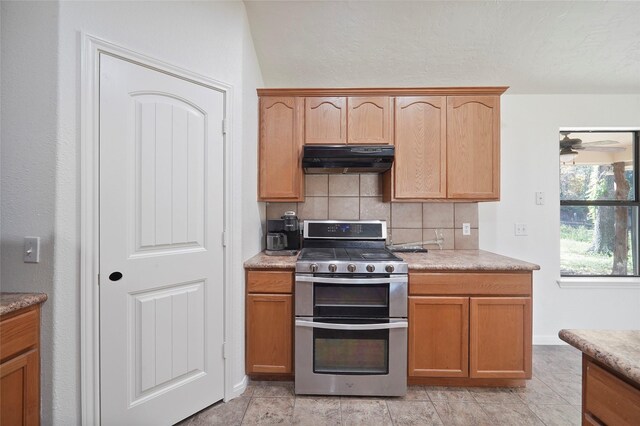 22981 Henson Rd, Montgomery, TX 77356 - kitchen featuring under cabinet range hood, tasteful backsplash, and double oven range