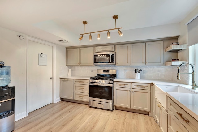 3202 Crossman St, Porter, TX 77365 - kitchen with stainless steel appliances, open shelves, light wood-style flooring, a sink, and backsplash
