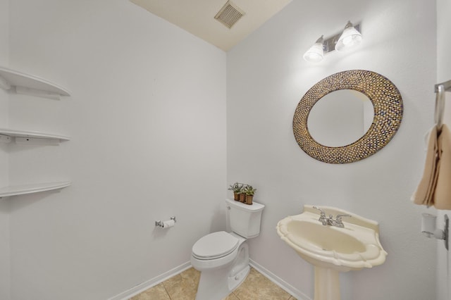 bathroom featuring toilet, tile patterned flooring, visible vents, and baseboards