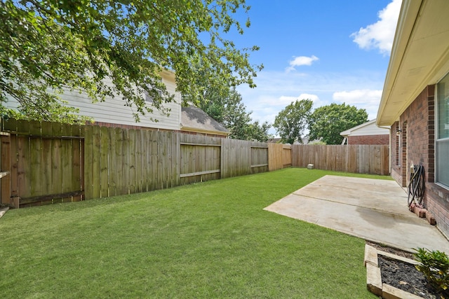 view of yard featuring a patio area and a fenced backyard
