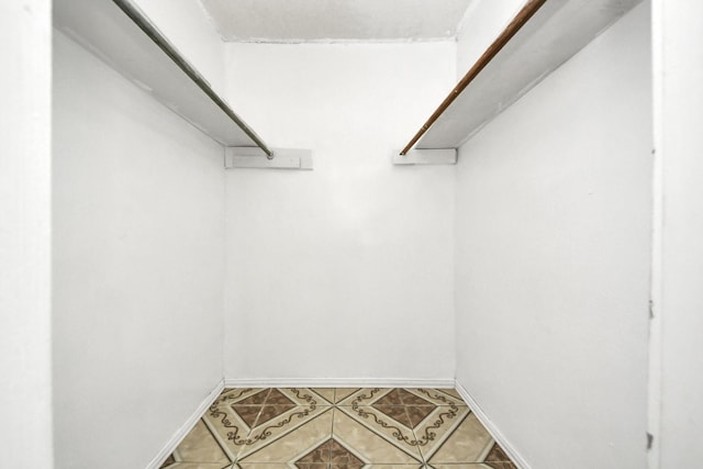 walk in closet with tile patterned floors