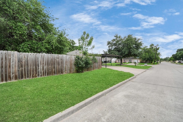 view of yard with a carport and driveway