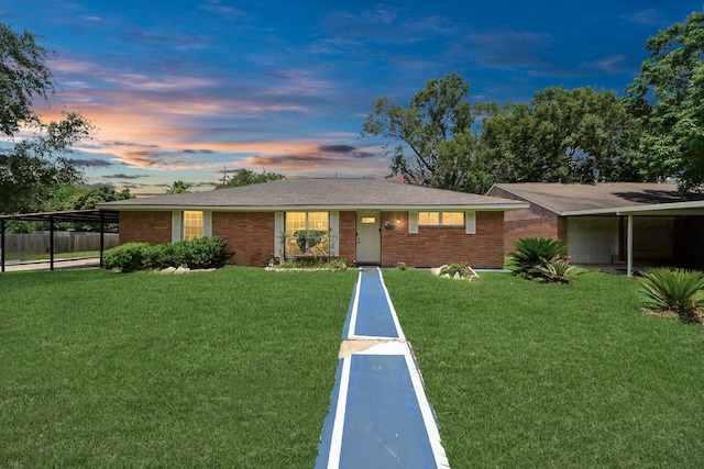 ranch-style home featuring brick siding and an attached carport