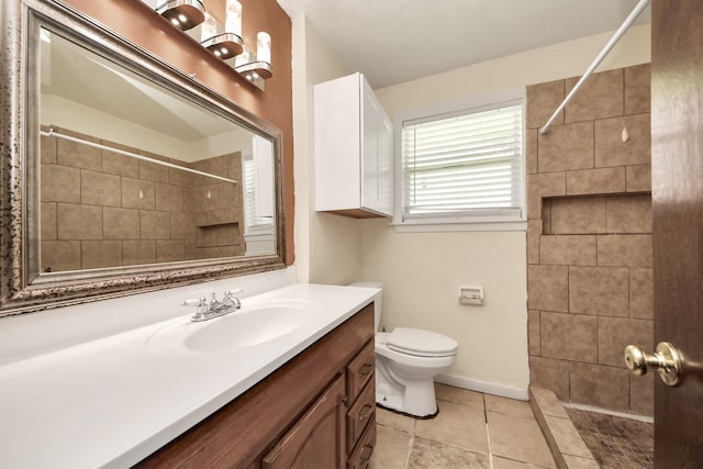 bathroom featuring toilet, vanity, and a shower