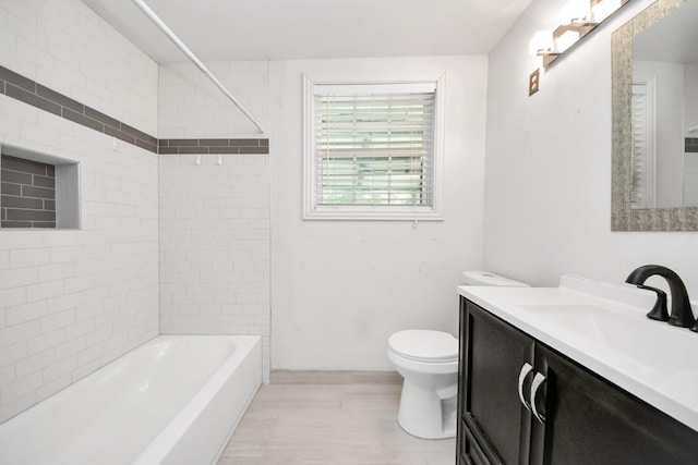 full bathroom featuring toilet, vanity, and wood finished floors
