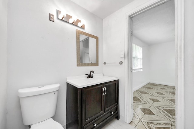 bathroom featuring tile patterned floors, toilet, and vanity