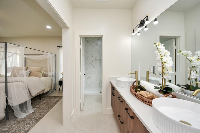 full bath featuring a marble finish shower, double vanity, and recessed lighting