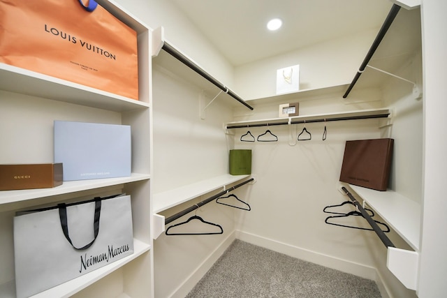 walk in closet with carpet