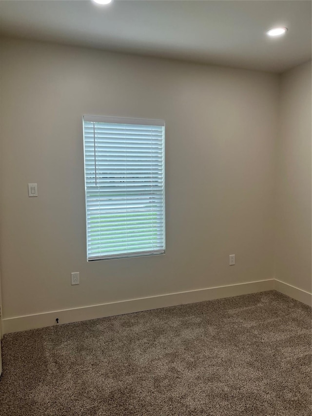 carpeted empty room with baseboards and recessed lighting