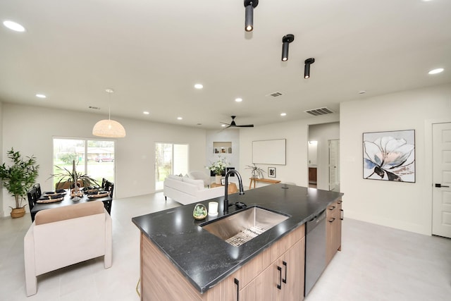 kitchen with a sink, dishwasher, a center island with sink, open floor plan, and light brown cabinetry