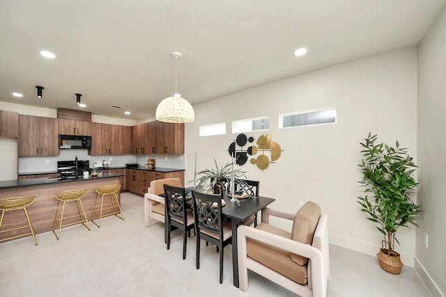 dining area featuring recessed lighting and baseboards