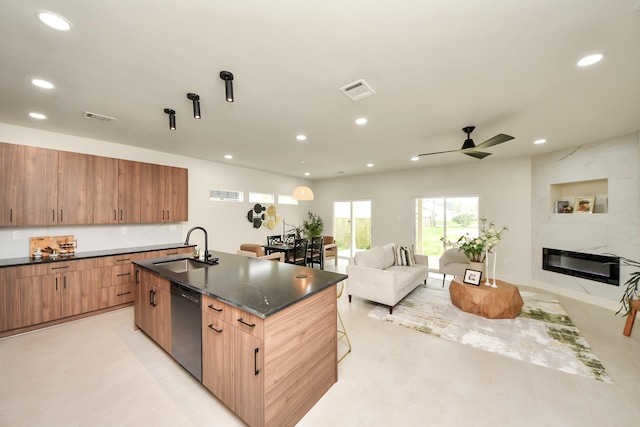 kitchen featuring black dishwasher, a sink, open floor plan, ceiling fan, and recessed lighting