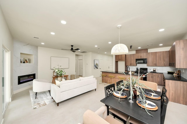 living room featuring recessed lighting, a ceiling fan, and a premium fireplace