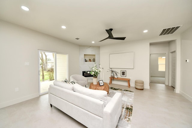 living area featuring a ceiling fan, recessed lighting, and baseboards