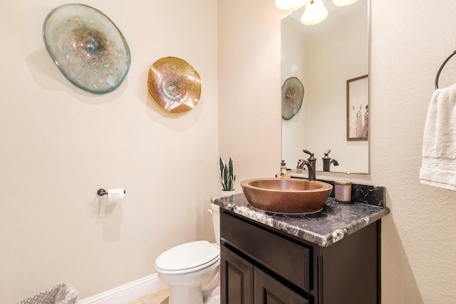 half bathroom with vanity and toilet