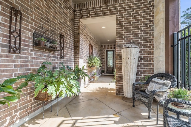 view of exterior entry featuring brick siding