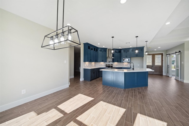 237 Crestview Dr, West Columbia, TX 77486 - kitchen with baseboards, a barn door, light countertops, blue cabinetry, and recessed lighting