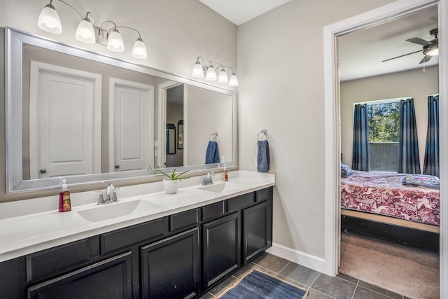 ensuite bathroom with a sink, ensuite bathroom, tile patterned flooring, ceiling fan, and double vanity