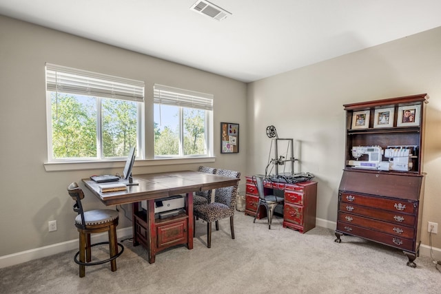 carpeted office space with baseboards and visible vents