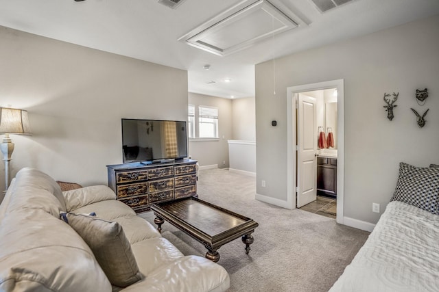 living room featuring attic access, visible vents, baseboards, and carpet floors