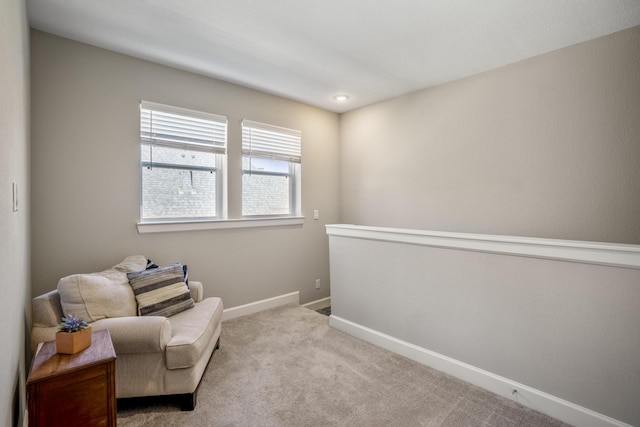 sitting room featuring baseboards and carpet flooring