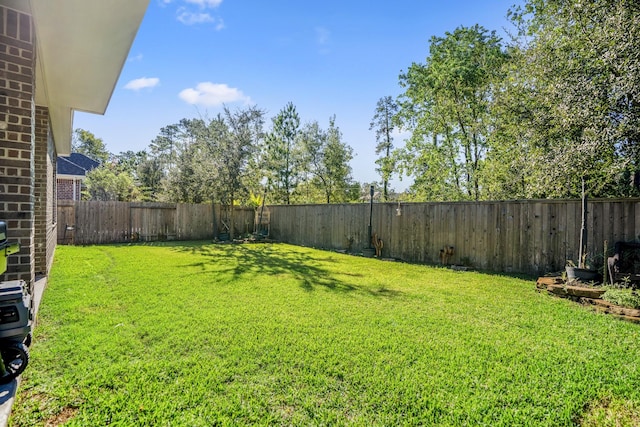 view of yard with a fenced backyard