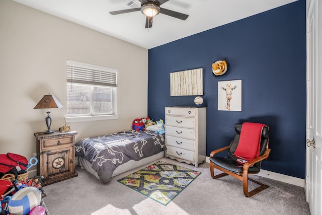 bedroom with a ceiling fan, baseboards, and carpet