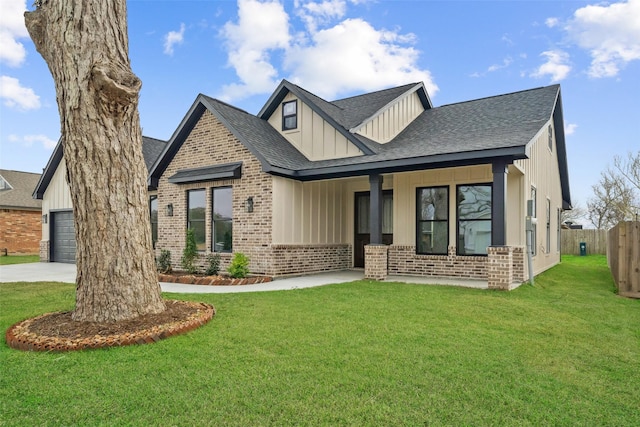 443 Wellshire Dr, West Columbia, TX 77486 - view of front of house featuring covered porch, a shingled roof, board and batten siding, a front yard, and brick siding