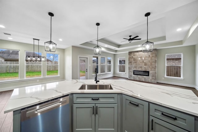 443 Wellshire Dr, West Columbia, TX 77486 - kitchen with a sink, a tray ceiling, open floor plan, ceiling fan, and dishwasher